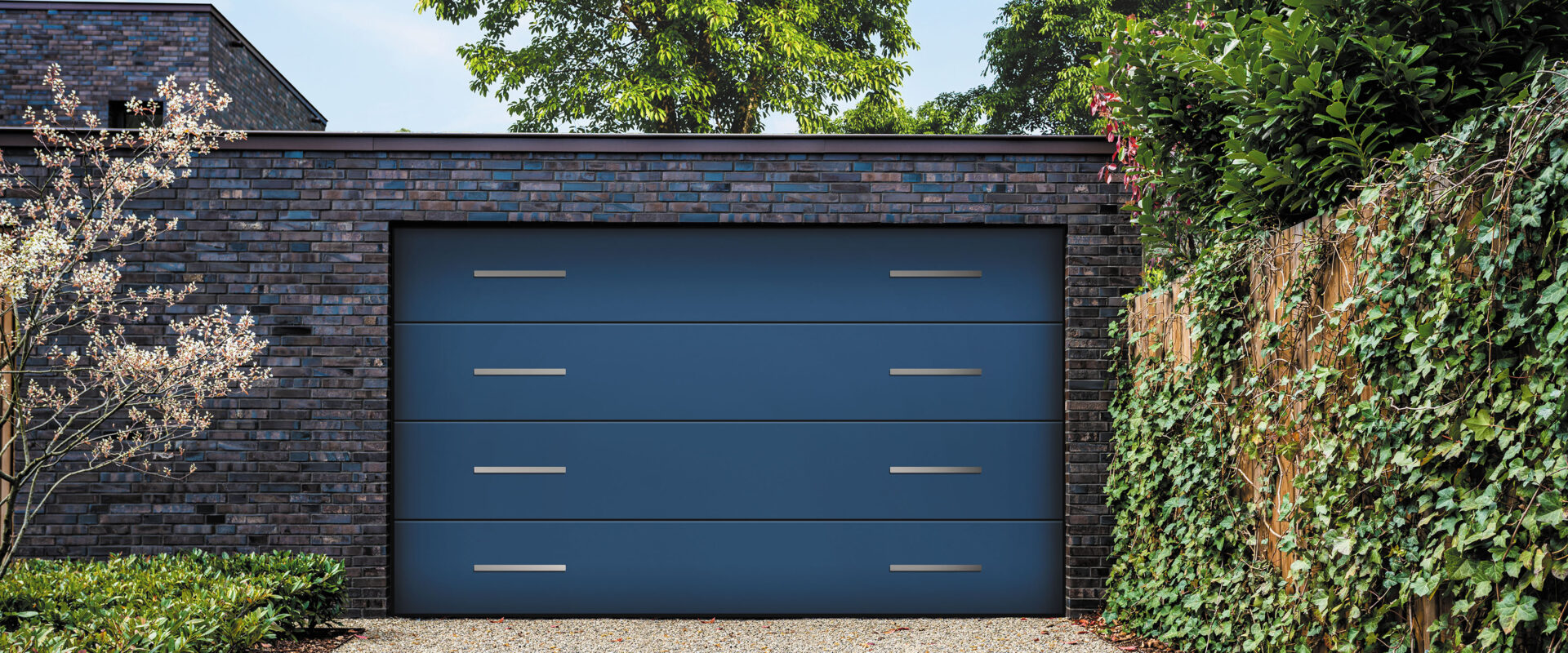 wide garage door and concrete driveway in front